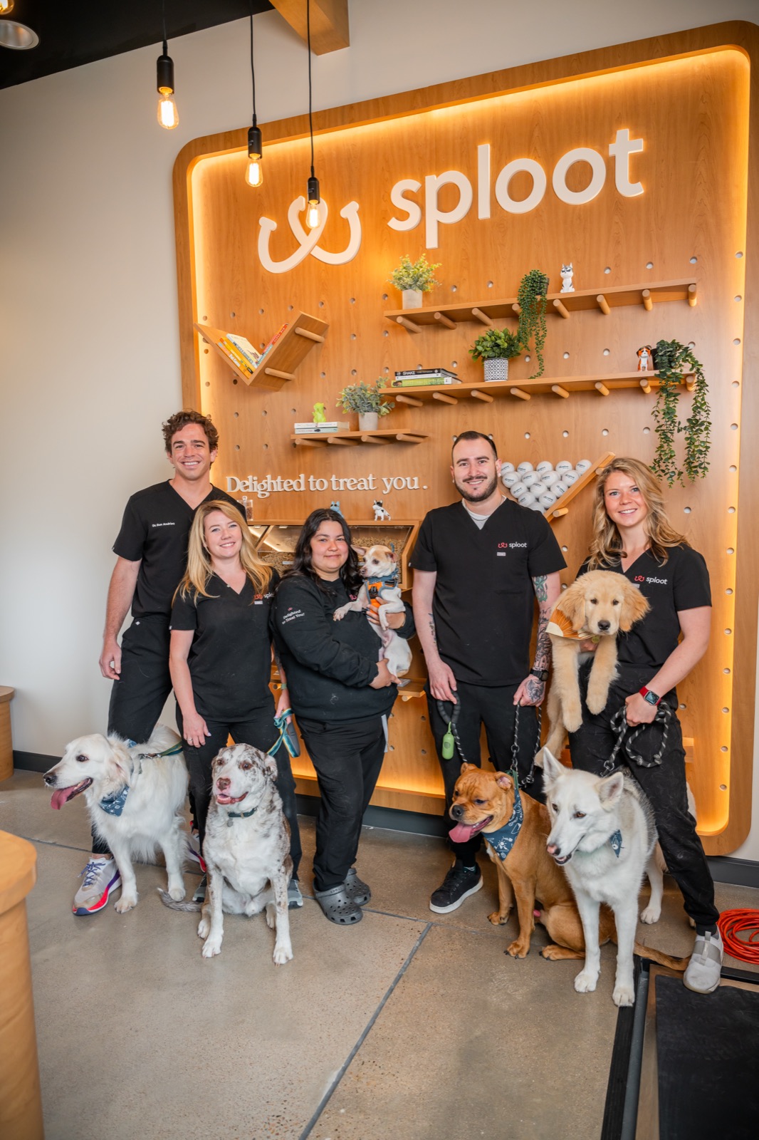 The Sploot team with their patients in front of the clinic wall